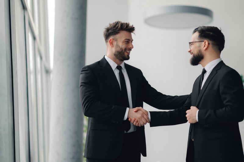 Two NVT Personnel Shaking Hands After A Meeting